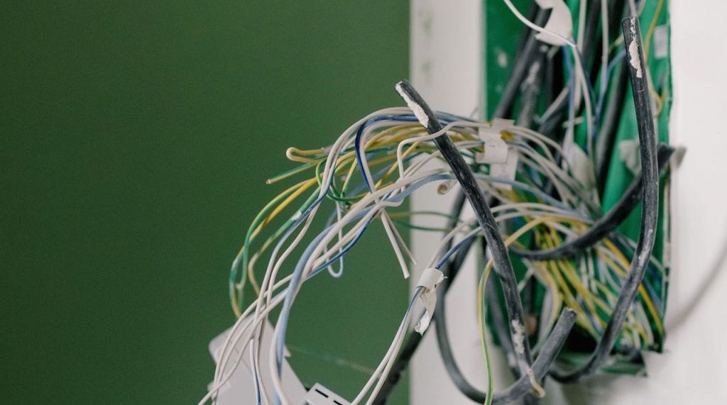 Mess of electric cables in wall