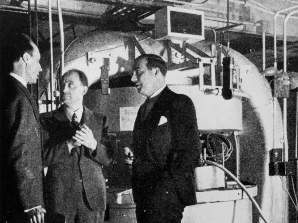 Dunning, Fermi and Mitchell in front of the cyclotron magnets